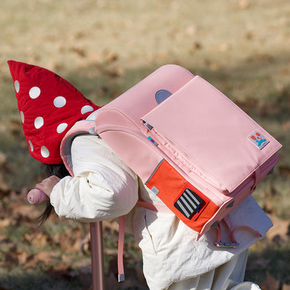 Child wearing Sakura Pink 3D Waist-Relief Backpack designed for comfort and waterproof durability for daily use.